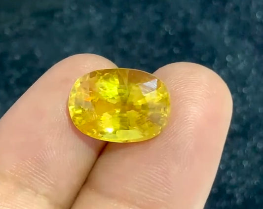 Yellow Sapphire on two fingers for scale