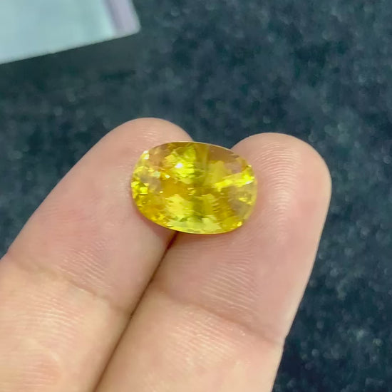 video of Yellow Sapphire on two fingers for scale
