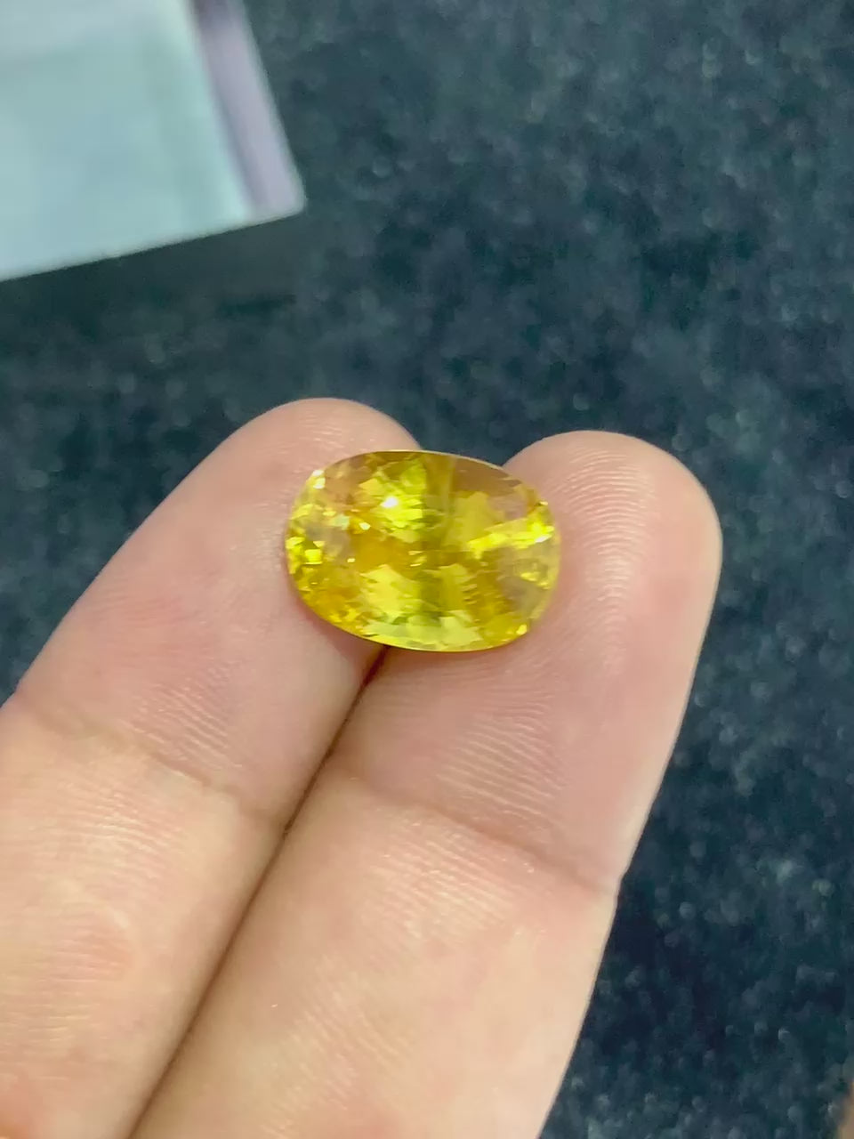 video of Yellow Sapphire on two fingers for scale